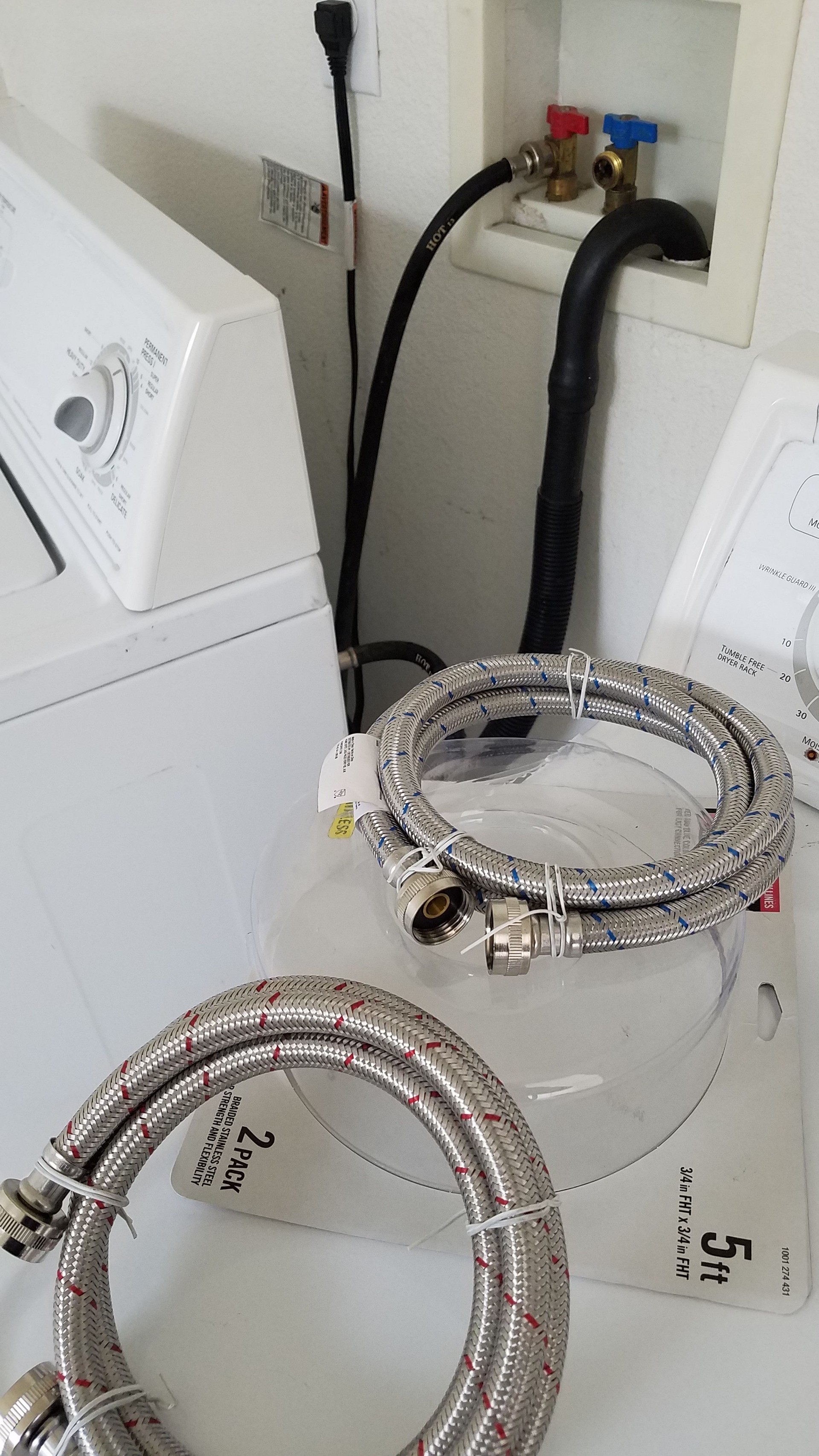 Hooking Up Washing Machine Water Hoses In a Home Laundry Room