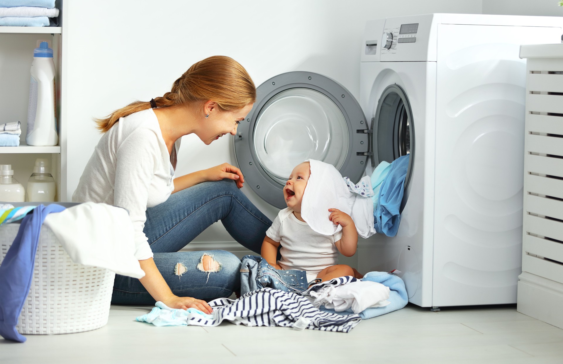 mother a housewife with a baby  fold clothes